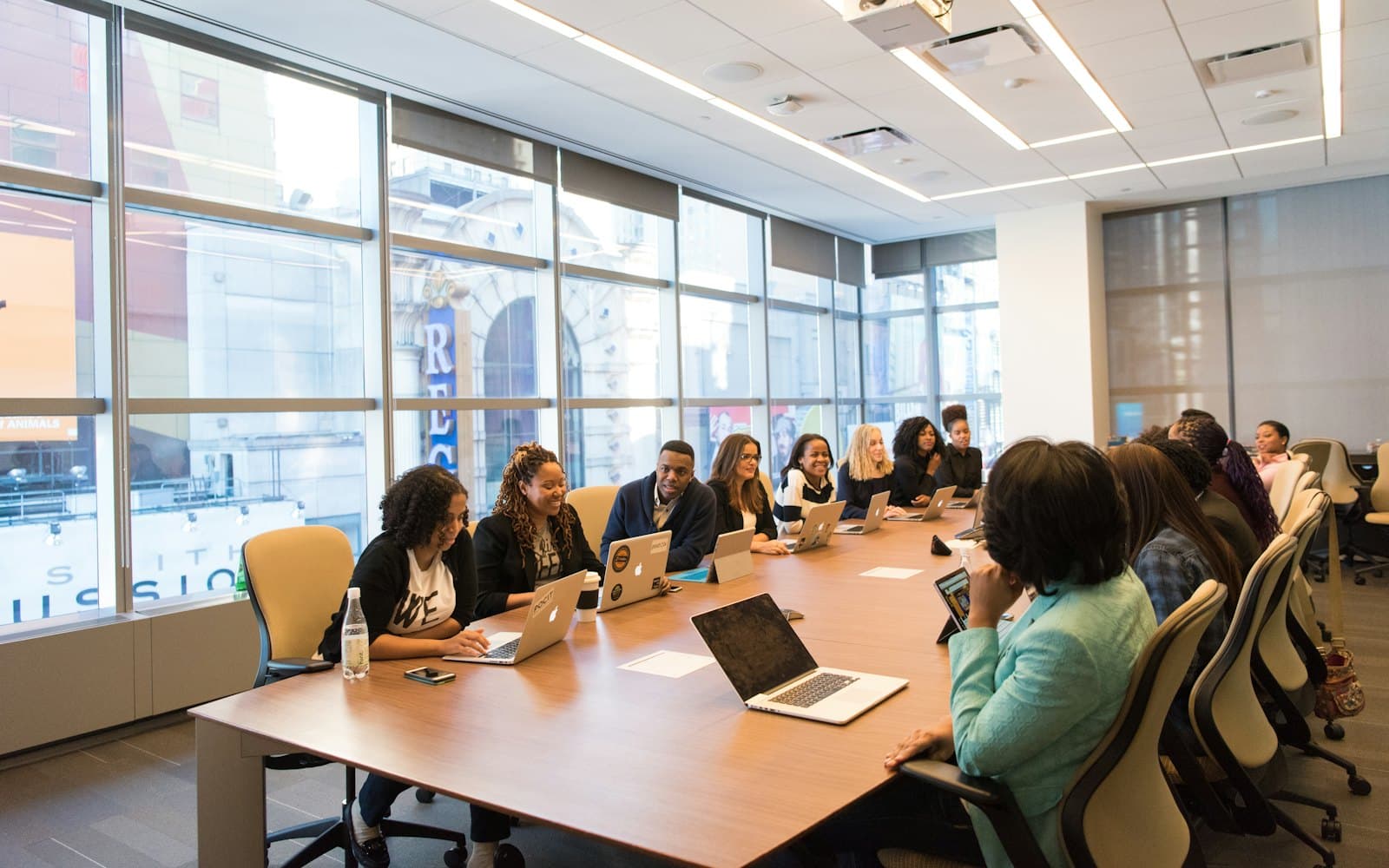 A board meeting around a table in a bright conference room